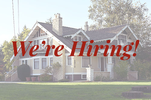Faded image of the brown and yellow craftsman-style Trethewey House with the words "We're Hiring!" over top in Heritage Abbotsford Red