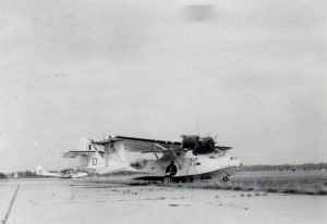 Black and white photo of two planes on a tarmac.